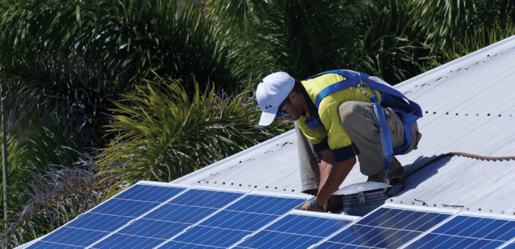 Electrician installing a solar panel