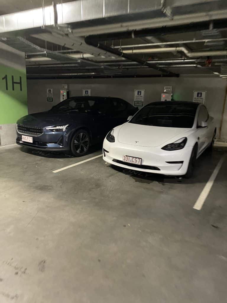 Underground carpark with two cars parked beside each other