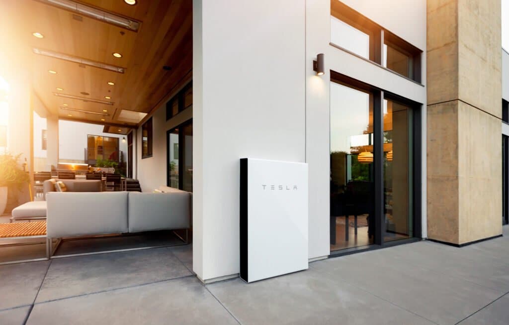 Picture of a house with a Home battery system from Tesla featuring outside of the house, next to the front door